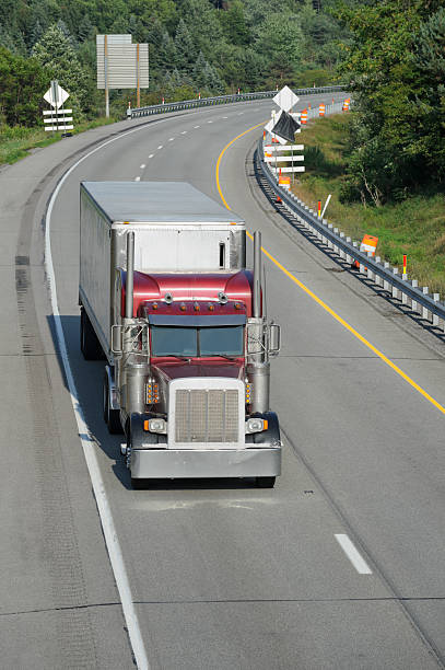 istock Trucks Moving on Highway, American Interstate in Evening Sunlight 175496162