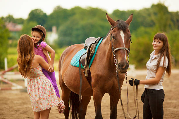 istock Child Riding Horse Outdoors. 175496461