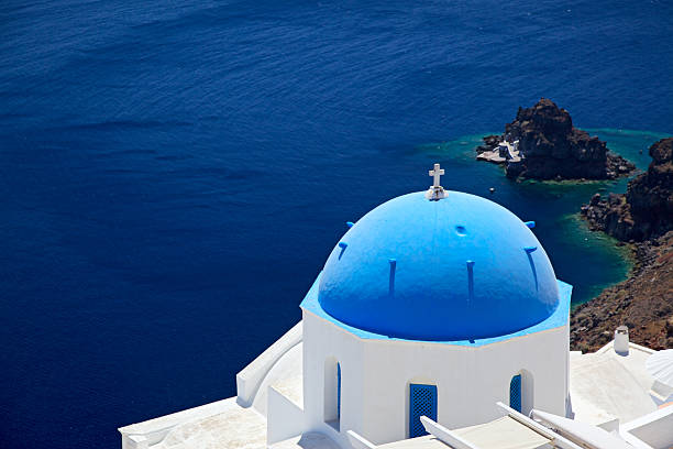 View of Santorini (Grece) with the stunning blue over white of its churches. Santorini is the most iconic landmark in the Aegean sea.