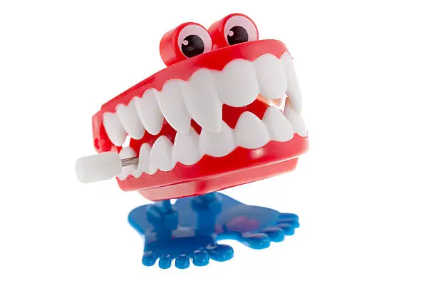 "Vintage chattering teeth toy, isolated on white."