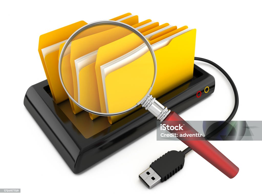 Searching for a file Magnifying glass searching folders standing on a portable hard drive.  Clipping path included. (Please note that clipping path will be available in the largest file size purchase.) Electronics Industry Stock Photo