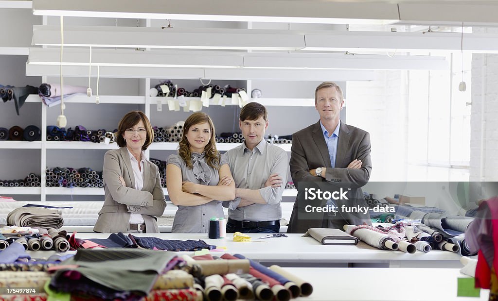 Family business Two generations of a family running a small business on textile. Family Stock Photo