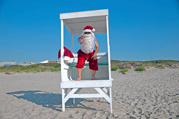 Santa Clause as a lifeguard on the beach stock photo