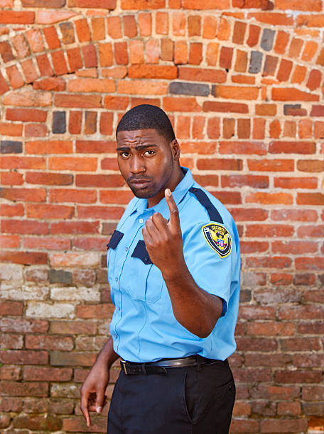 istock Afro american Security officer beckoning in front of brick building. 175498542