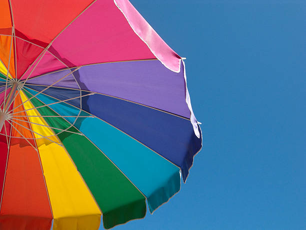 istock Colorful Beach Umbrella against Clear Blue Sky 175498547