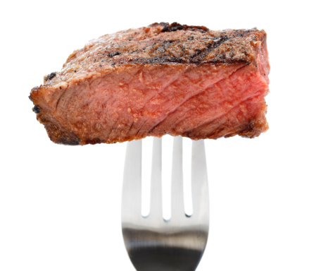 Bite size portion of grilled T-Bone steak