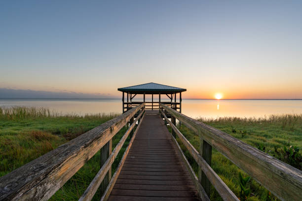 Vibrant Sunrise Over a Boardwalk and Dock at Lake Apopka near Orlando in Central Florida stock photo