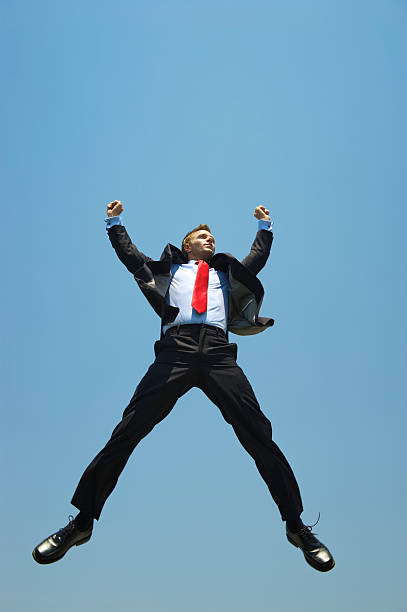 istock Businessman Leaps into Blue Sky with Arms Raised 175499244
