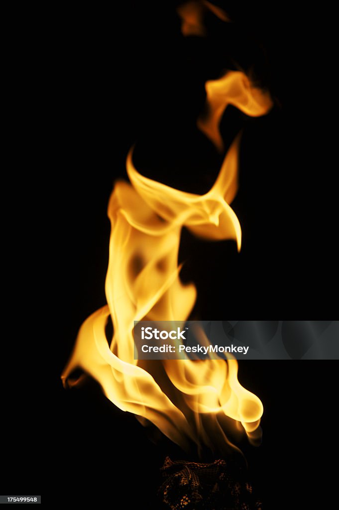 Flame Close Up on a Torch Black Background Flames from a torch lick the night air Fire - Natural Phenomenon Stock Photo