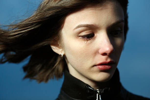 portrait of a young woman grieving stock photo
