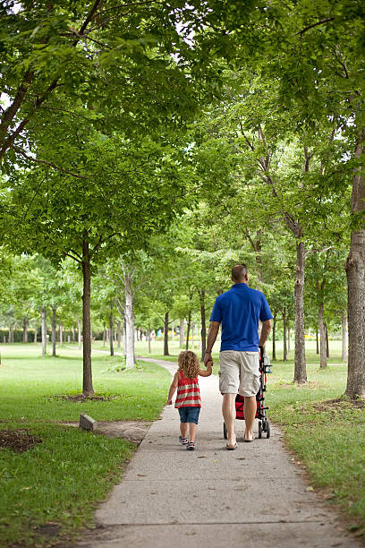 istock Dad and Daughter Walking in the Park 175499876