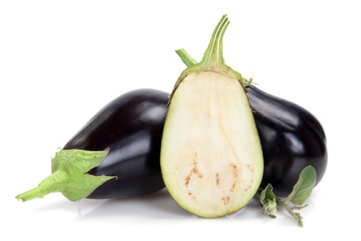 Eggplants and half on white background