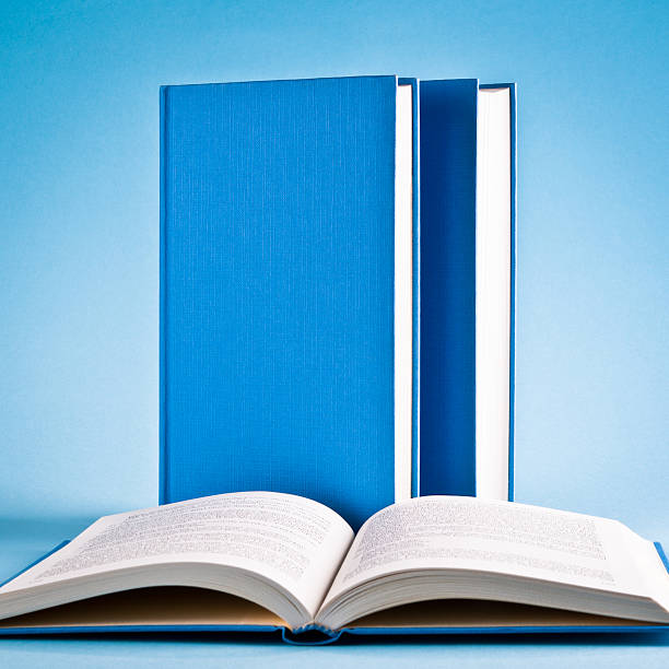 istock Open book and books in raw isolated on blue background 175500717
