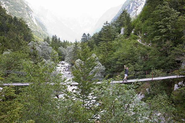 istock Man crossing rope bridge over the River Soca Slovenia 175500860