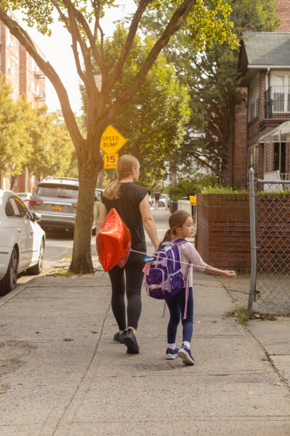 istock mother and daugher walking after school 1755016471