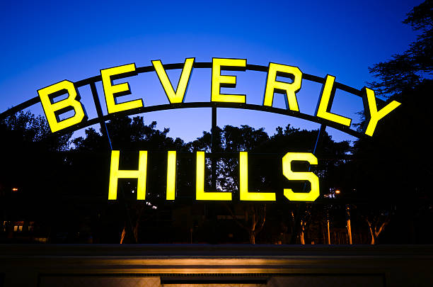 A lit up Beverly Hills sign at night