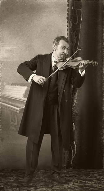Portrait of a musician standing on a stage holding an instrument with a protective face mask on