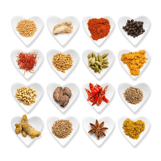 Herbal medicine concept,top view of spices and herbal medicines with red heart on grinding stone with a black background