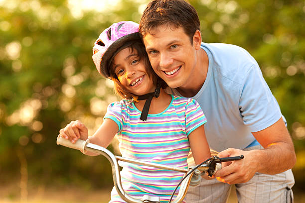 istock Father Teaching Child to ride a bicycle. 175502268