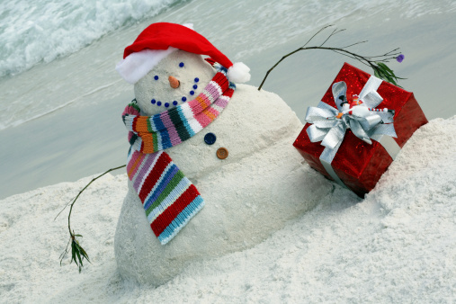 Christmas time in Florida!  Very creative snowman made of sand wearing Santa Hat on the Florida Beach in the panhandle of Florida.