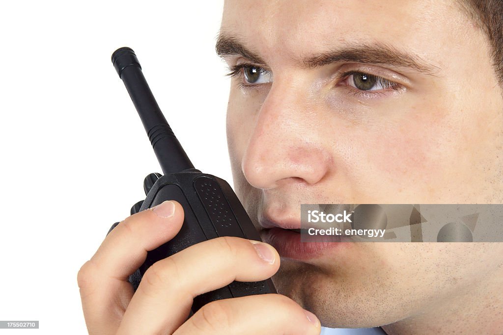 Young Security Staff Young security staff is talking with walkie-talkie Adult Stock Photo