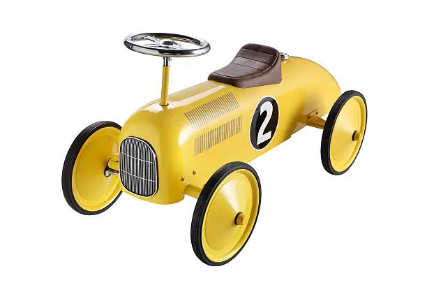 Photo of A yellow toy car with big wheels and a number 2 on the side