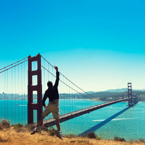 istock Man jumping against the San Francisco golden gate bridge 175502841