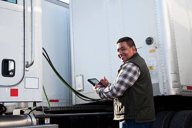 Hispanic truck driver with digital tablet