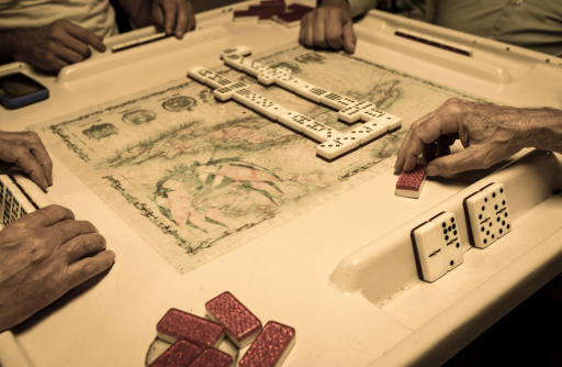 Four old cuban exiles playing domino in calle ocho (miami)