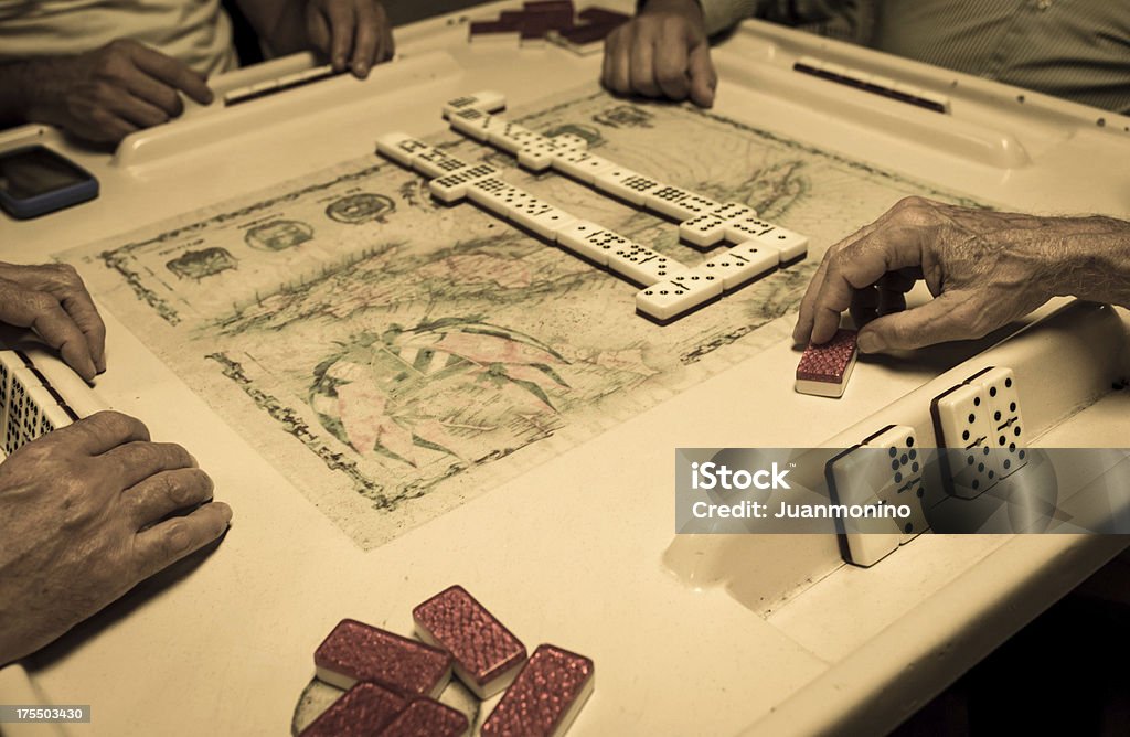 Domino in Miami Four old cuban exiles playing domino in calle ocho (miami) Little Havana Stock Photo