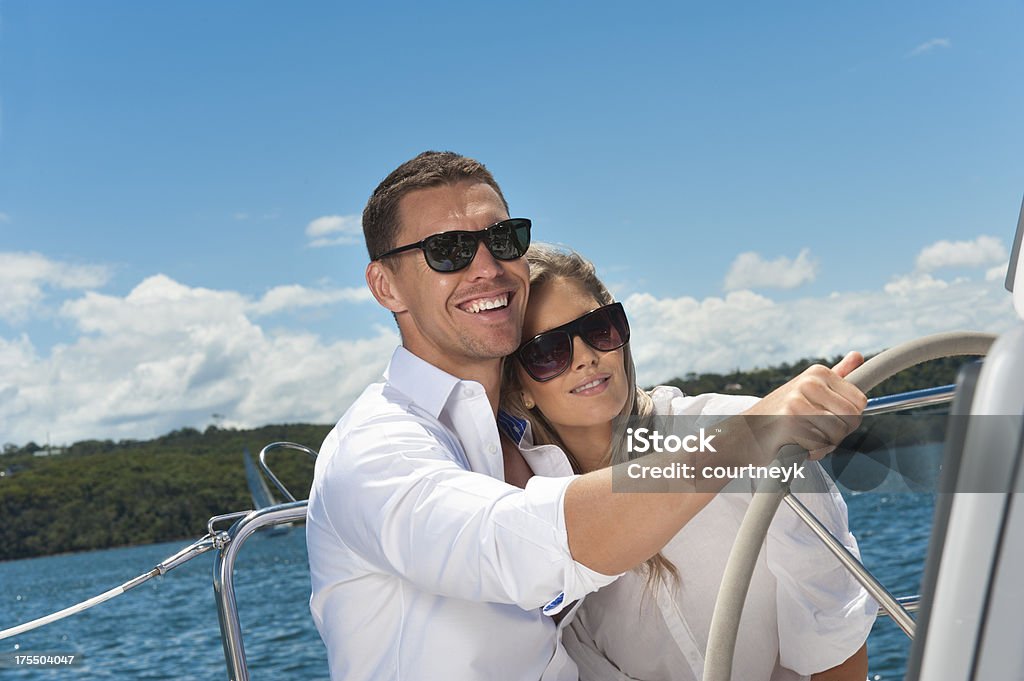 Heureux couple conduite un bateau à voile - Photo de Conduire libre de droits