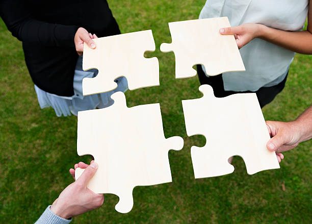 istock Teamwork with large group of people and a jigsaw puzzle 175504053
