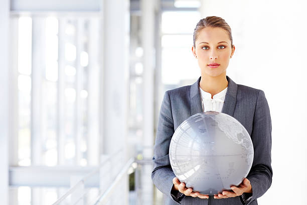 istock Female Corporate Executive Holding Reflective Globe 175504200