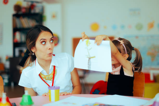 istock Preschool Student Showing her Artwork to her Teacher 1755046224