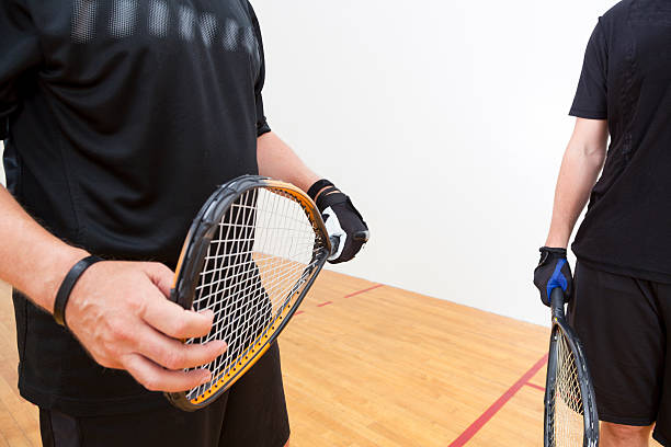 Racquetball Two men playing racquetball on court. racketball stock pictures, royalty-free photos & images