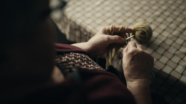 SLO MO High Angle Closeup of Hands of Senior Woman Knitting with Needles at Home