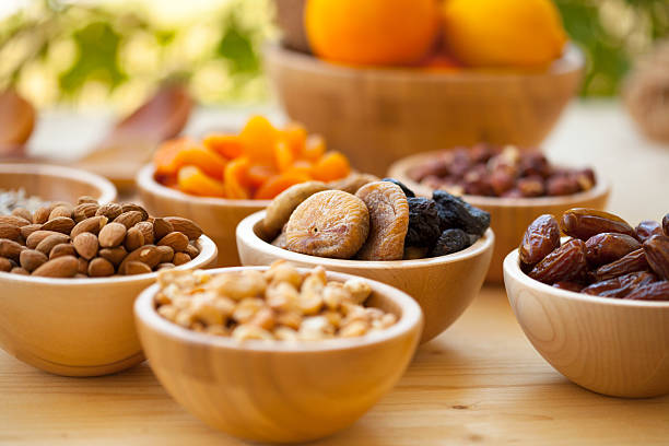 Dried Date Fruits,designed in plate with apricot and nuts.On white surface with copy space.Ramadan Concept