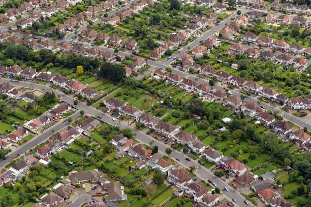 "Ariel shot of an a typical British development of houses, bungalows and domestic gardens in the London suburb. It could be a suburb of any city in the UK.England, UK"