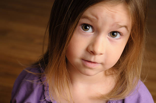 Close  up, color image of a four-year-old girl gazing into the camera.