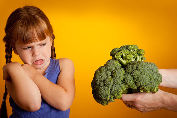 Little Girl Making Face at Broccoli