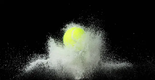 Photo of Tennis training practice in middle of snow night. Sport training tennis ball falling down snow, heavy big small size snows. Freeze shot on black background isolated overlay.