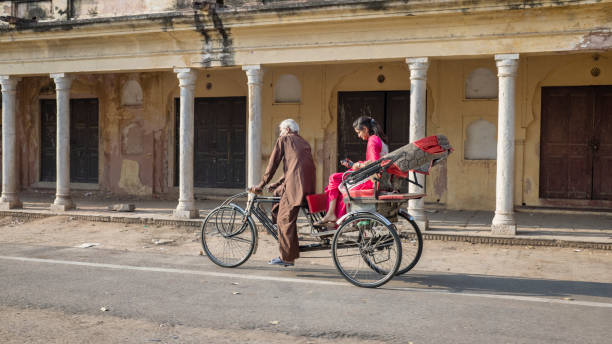 istock Indian man riding his bicycle rickshaw with a young woman, Jaipur 1755057566