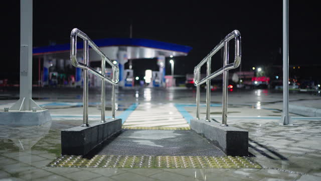 Handicap-accessible ramps in parking lots at night.