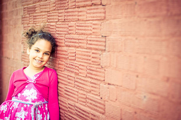 Royalty free stock photo of little girl (5-6) looking pensive. Shot with shallow depth of field.This file has a