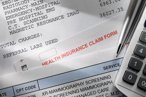 A health insurance claim form along with a couple of medical bills.To see more of my medical images click on the link below
