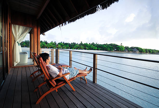 Relaxing On Deck Chair of Beach House - XLarge Relaxing On Deck Chair of Beach House cottage life stock pictures, royalty-free photos & images