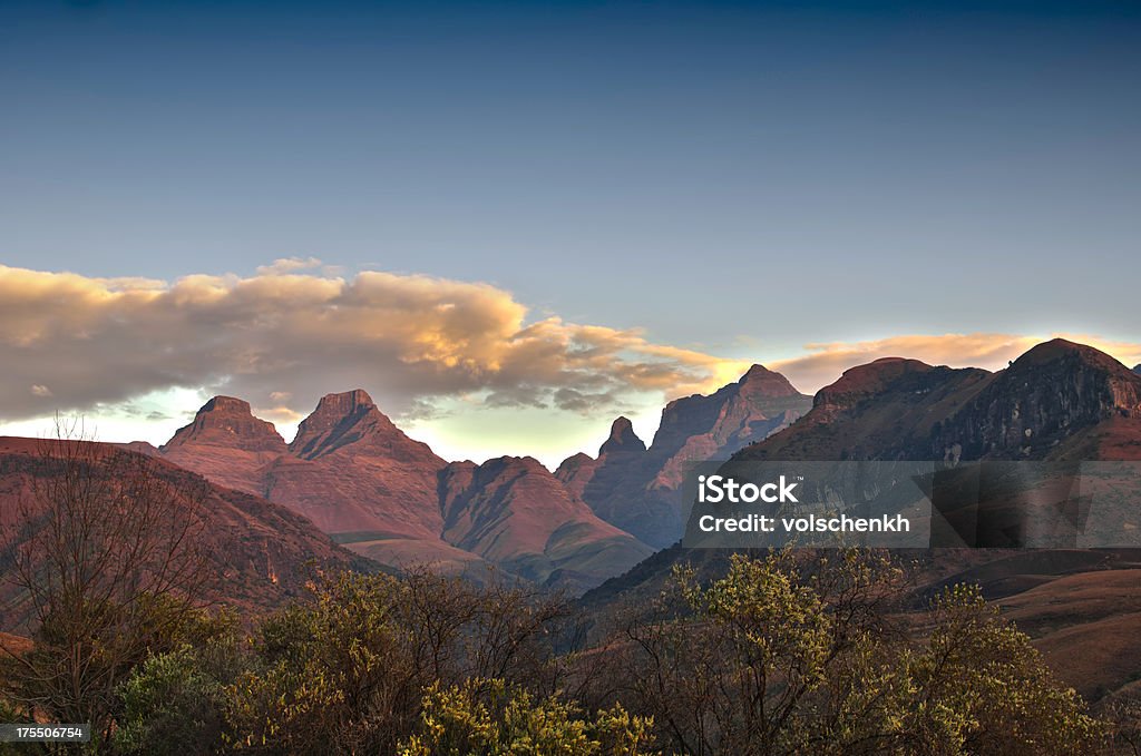 Cathedral Peak "Sunrise over Cathedral peak in the Drakensberg, Kwazulu-Natal, South Africa. This is an HDR image." Drakensberg Mountain Range Stock Photo