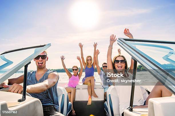 Cheerful Group Of Young People Enjoying In Speedboat Ride Stock Photo - Download Image Now