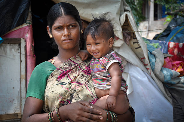 Motherhood Indian Rural woman with her child india poverty stock pictures, royalty-free photos & images