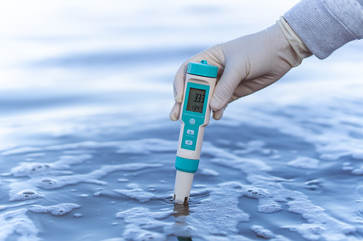 technician use the Professional Water Testing equipment to measure the water quality at the public canal. Portable multi parameter water quality measurement ,water quality monitoring concept